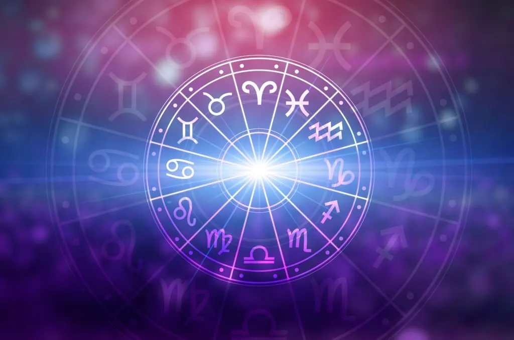 Glowing zodiac wheel against a violet sky